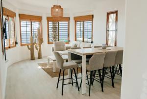 a dining room with a table and chairs at Villa Bahari by Seaward Suites in Villajoyosa