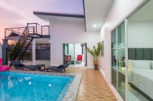 a house with a swimming pool and a bedroom at Lark Pool Villa Aonang Krabi in Ao Nang Beach