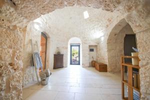a hallway in a castle with a stone wall at TD Trulli Albapetra Pool Olive Trees in Polignano a Mare