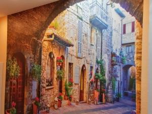 a painting of an alleyway in an old town at Casa Mediteran NEU in Reichensachsen