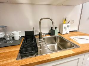 a kitchen counter with a sink and a stove at Home and Sea in Gdańsk