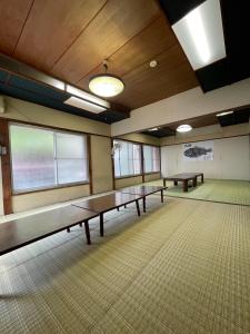a room with ping pong tables in it at 素泊まり民宿とみや in Oshima