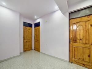 an empty room with two wooden doors on the wall at OYO Flagship 83165 Hotel Om Shanti in Khagaul