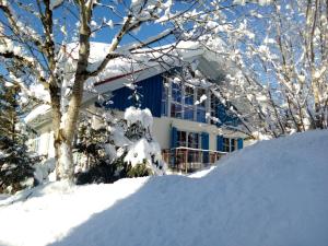 a house with a pile of snow in front of it at Ferienhaus Kirsch in Missen-Wilhams