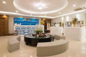 a lobby with a table and some chairs and a room at Galina Hotel & Spa in Nha Trang +142 photos
