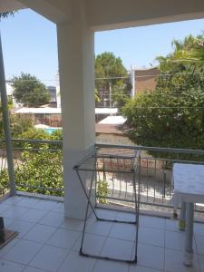 a balcony with a bird cage on a building at Beldibi Apart Homes in Antalya