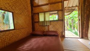 a couch in a room with a window at Sun Moon Pai Bungalow in Pai