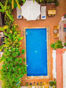 an overhead view of a swimming pool with an umbrella at Ravoeun Angkor Boutique in Siem Reap
