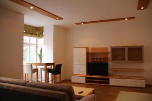 a living room with a couch and a table at Hotel Goldene Krone Innsbruck in Innsbruck