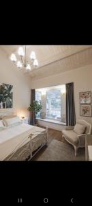 a bedroom with a large bed and a window at Villa Platani Luxury Suite in Cianciana