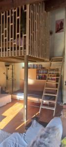 a room with a bunk bed and a book shelf at Vakantiehuis “Le Verbe” in de Drôme Provençale in Le Poët-Laval
