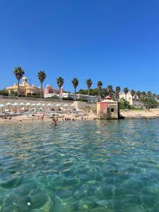 a group of people in the water at a beach at A'mmare Rooms&Apartments Santa Maria di Leuca in Leuca