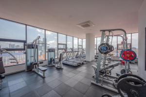 a gym with treadmills and machines in a building at AMATA Residence in Phnom Penh