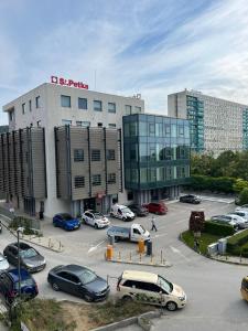 a parking lot with cars parked in front of a building at Apartment Sanik in Varna City