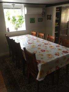 a dining room table with a floral table cloth on it at Charmig Ölandsgård in Köpingsvik