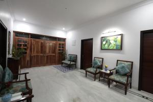 a lobby with two chairs and a wall with a door at Jai Villa - A Boutique Hotel in Jaipur