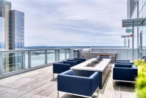 a balcony with blue chairs and a table on a building at Downtown 2br w Gym wd BBQ nr dining shops SEA-402 in Seattle