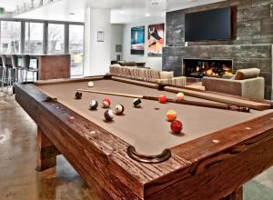 a pool table in a living room with a fireplace at Ballard 2BR w Fire Pit Gym nr Farmers Mkt SEA-282 in Seattle