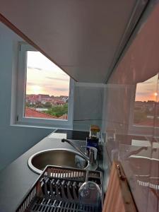 a kitchen with a sink and a window at Joma in Mali Mokri Lug