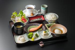 a tray of food with rice and vegetables and a cup of coffee at Hotel Fuji Tatsugaoka in Fujiyoshida