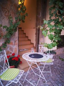 a table and chairs on a patio with stairs at ВИЛА СВИЛА in Sozopol