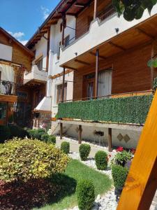 a building with plants on the side of it at NIKI HOUSE in Bansko