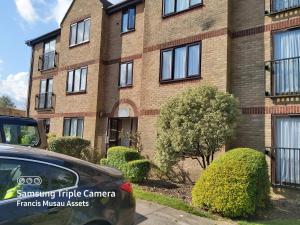 a car parked in front of a brick building at Green Door-The Malting- Specious 1st Floor-One Bedroom Apartment -Fully Furnished-Quiet- Free Parking -Dunstable in Dunstable