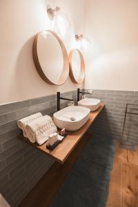 a bathroom with two sinks and a mirror at Villa Platani Luxury Suite in Cianciana