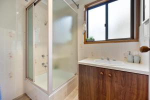 un baño con ducha y lavabo en INVERLOCH Beach House, en Inverloch 33 fotos más