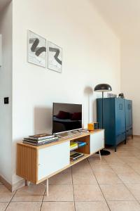 a living room with a table and a blue cabinet at Appartamento Baia del Re - Navigli in Milan