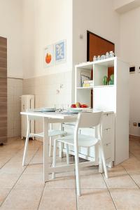 a white dining table and chairs in a kitchen at Appartamento Baia del Re - Navigli in Milan