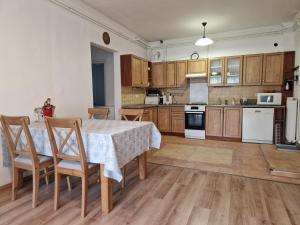 a kitchen with a table and chairs in a room at Clarissa Apartman Eger in Eger