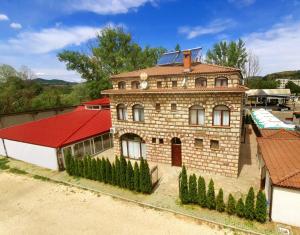 an old brick building with a red roof at Hotel Divna in Krumovgrad