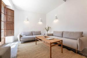 a living room with a couch and a coffee table at El Convento de Biniamar in El Port de la Selva +39 photos