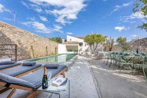a villa with a swimming pool and a patio at El Convento de Biniamar in Selva