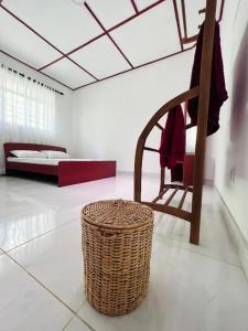 a room with a wicker chair and a bed at The Cinnamon Villa Kandy in Kandy