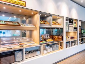 a bakery counter with many different types of food at B&B Hotel Rosenheim in Rosenheim