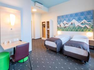Postel nebo postele na pokoji v ubytování B&B Hotel Rosenheim