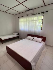 a bedroom with a large bed and a window at The Cinnamon Villa Kandy in Kandy