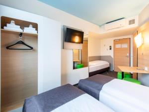 Postel nebo postele na pokoji v ubytování B&B Hotel Rosenheim + 21 fotografií