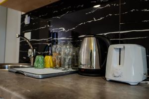 a kitchen counter with a toaster and wine glasses at Makedon Apartments with FREE PARKING in Ohrid
