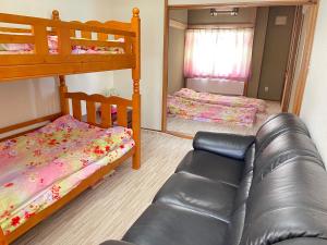 a living room with two bunk beds and a couch at Kien in Sapporo