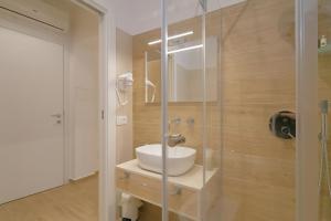 a bathroom with a sink and a glass shower at Stella del Capo 3 stelle Affittacamere in San Vito lo Capo +46 photos