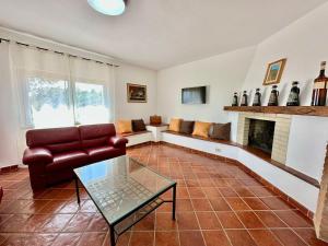 a living room with a couch and a fireplace at Villa San Bartolo in San Vincenzo