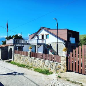 une maison avec un mur en pierre et une clôture dans l'établissement Villa Shuaipaj, à Gjirokastër