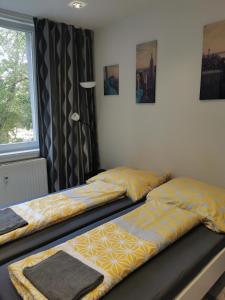 two beds sitting next to a window in a bedroom at MODRÝ APARTMÁN, Račianska 29, BRATISLAVA in Bratislava
