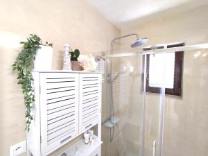 a bathroom with a shower and a white cabinet at Apartmán BRAĆKI CVIJET in Sutivan