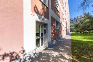 a pink building with a window on the side at Sofia Apartment - With parking in Bratislava