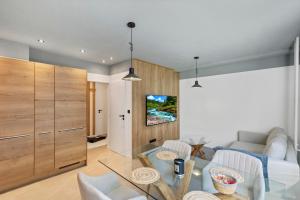 a living room with a glass dining room table at Sofia Apartment - With parking in Bratislava