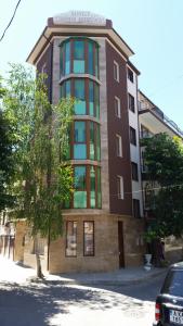 a building on a street with a car in front of it at Guest rooms Sveti Nikola in Pomorie